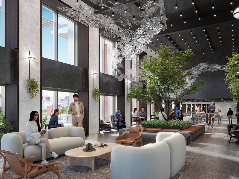 Lounge with high ceilings, tree planter, and modern seating at 40 Thorndike's amenity space
