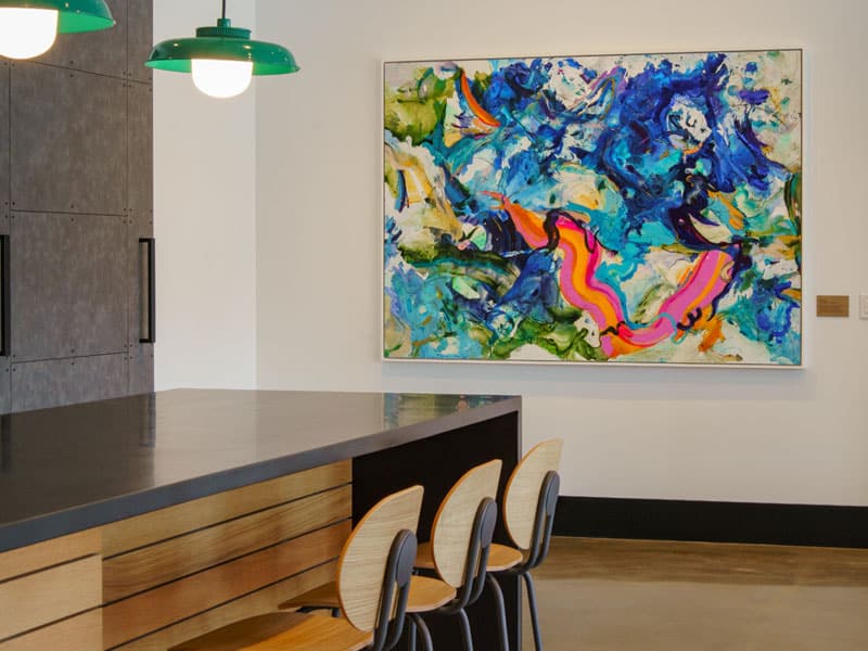 Colorful modern art displayed in the lobby of 40 Thorndike with seating area
