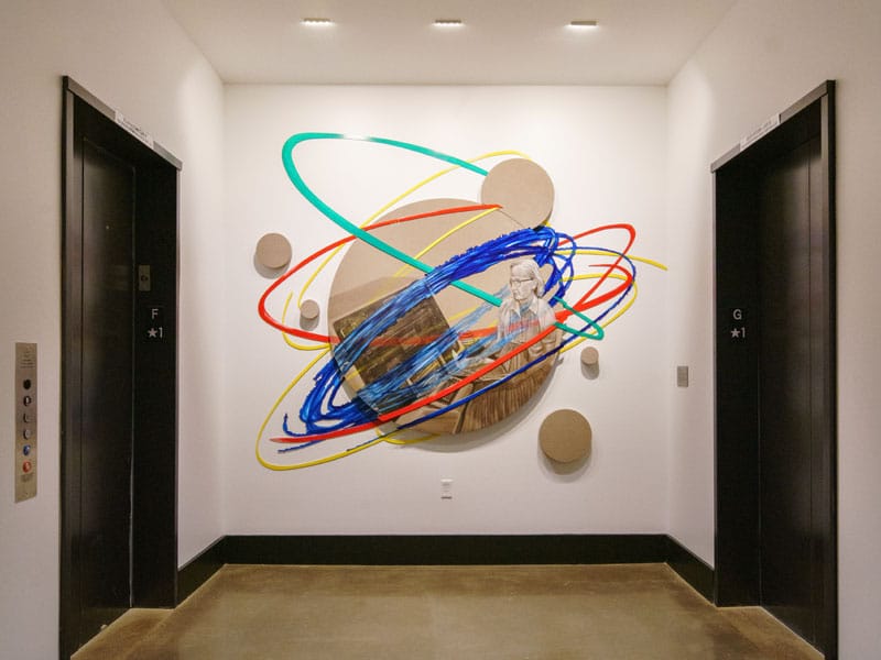 Abstract wall art featuring colorful swirling lines in the lobby of 40 Thorndike