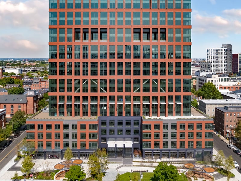 Exterior view of 40 Thorndike building, featuring a red brick facade and large glass windows