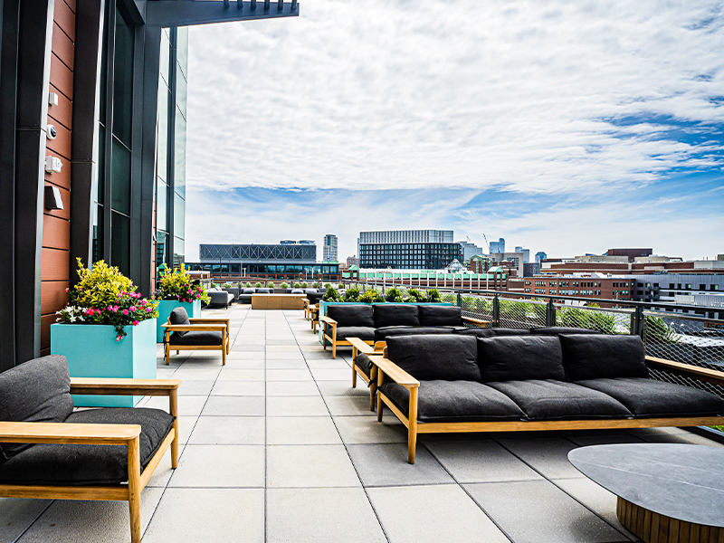 Outdoor terrace with city skyline backdrop, offering a scenic and relaxing environment