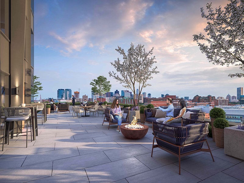 40 Thorndike rooftop terrace at sunset, featuring lounge seating and panoramic views
