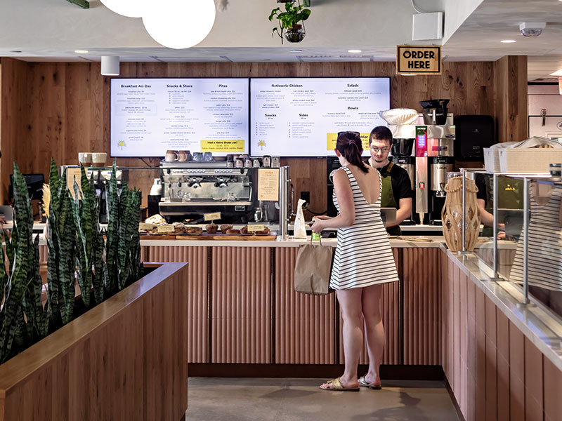 Barista interacting with a customer in a stylish local cafe close to 40 Thorndike office building.
