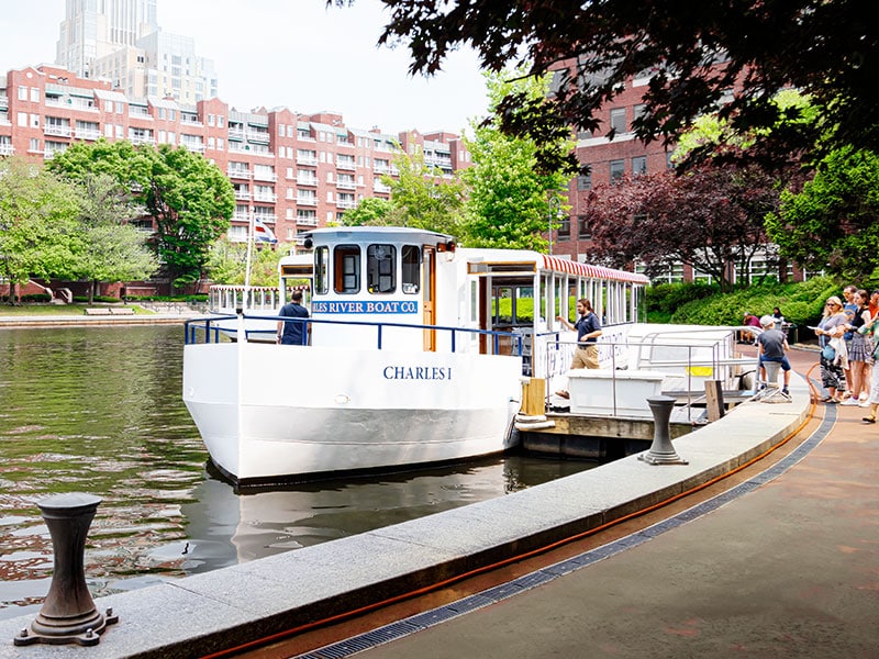 Water taxi at Charles River with nearby residential buildings, accessible to 40 Thorndike area.