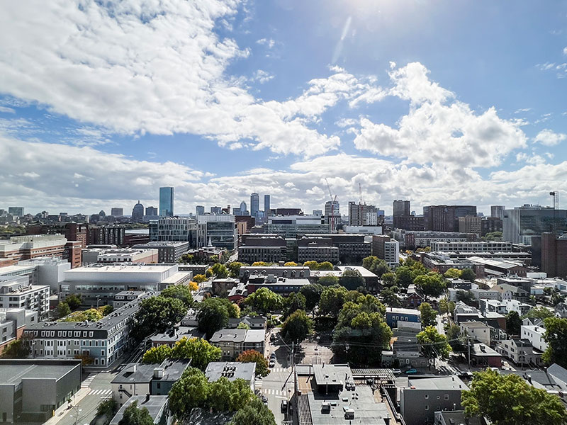 Panoramic view of East Cambridge skyline from 40 Thorndike, featuring urban developments and clear skies