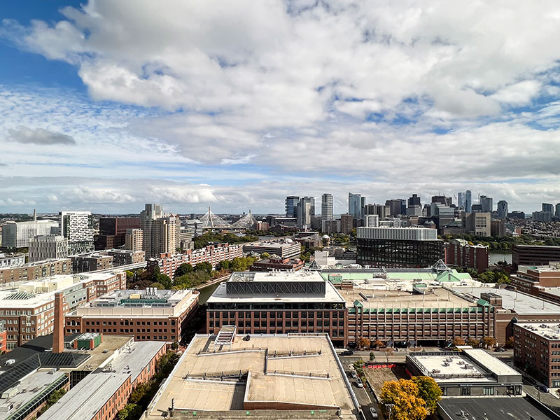 High-rise view of East Cambridge from 40 Thorndike, showing dense residential areas and blue skies