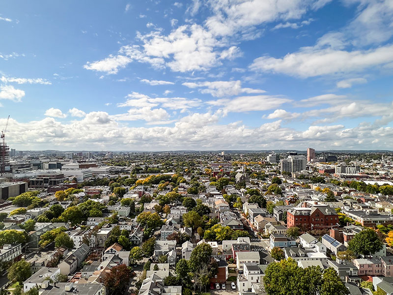 Cambridge's West view showing houses, developing construction, and bright skies with clouds