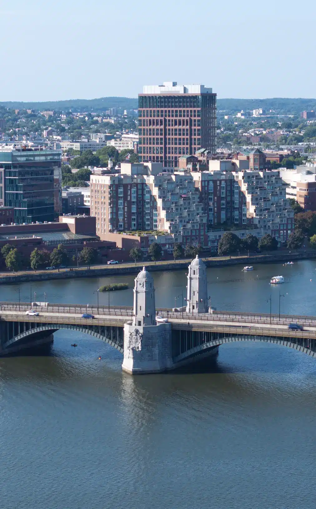 Aerial view of Longfellow Bridge connecting Cambridge and Boston with surrounding buildings and river.